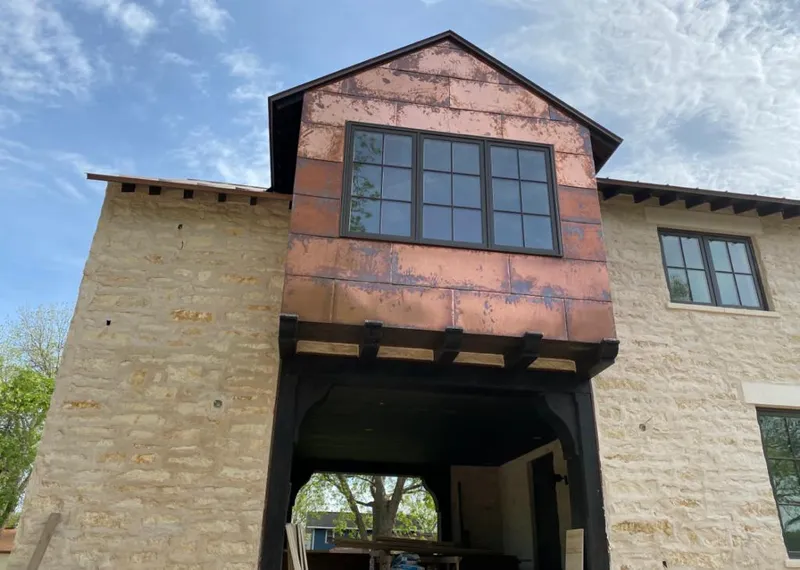 Copper metal panel facade on a stone building for Metal Roof Coating in Armada