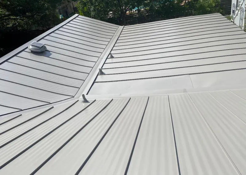 Solar attic fan installed on a metal roof for Roof Ventilation in Armada